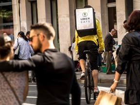 A cycle courier for meal delivery service Uber Eats rides past in Lille, France on September 2, 2017. The Canadian government's labour measures in response to the COVID-19 crisis are of little use to workers in the gig economy, Nura Jabagi writes.