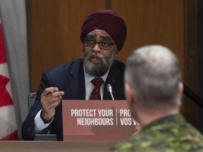 Chief of Defence Staff Jonathan Vance looks on as National Defence Minister Harjit Sajjan speaks during a news conference in Ottawa, Monday, March 30, 2020.