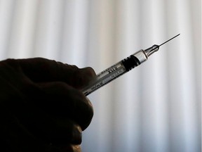 FILE PHOTO: A doctor prepares a syringe as part of the start of the seasonal influenza vaccination campaign in Nice, France October 24, 2018.   REUTERS/Eric Gaillard/File Photo