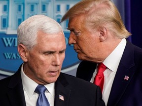 U.S. President Donald Trump passes U.S. Vice-President Mike Pence during a news conference on the coronavirus outbreak at the White House in Washington on Feb. 29, 2020.