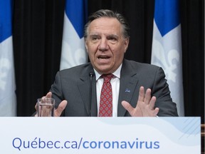 Quebec Premier Francois Legault responds to reporters questions at the daily news conference on the COVID-19 pandemic, Friday, March 20, 2020 at the legislature in Quebec City.