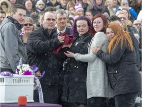 Francis Boyer and Caroline Sarrazin, parents of Océane Boyer, 13, and their children console each other after releasing a dove after a funeral service on Friday, March 6, 2020, in Lachute. Boyer was murdered last week while walking to school.