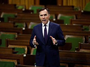 Canada's Minister of Finance Bill Morneau speaks in the House of Commons as legislators convene to give the government power to inject billions of dollars in emergency cash to help individuals and businesses through the economic crunch caused by the novel coronavirus outbreak, on Parliament Hill in Ottawa, Ontario, Canada March 25, 2020. REUTERS/Blair Gable