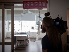 A cameraman films a negative pressure room at Montreal’s Jewish General Hospital during a news media tour on March 2, 2020 of quarantine facilities for treating COVID-19 patients.