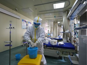 Medical workers in protective suits disinfect an intensive care unit (ICU) ward of Union Jiangbei Hospital in Wuhan, the epicentre of the novel coronavirus outbreak, Hubei province, China March 12, 2020. Picture taken March 12, 2020. China Daily via REUTERS  ATTENTION EDITORS - THIS IMAGE WAS PROVIDED BY A THIRD PARTY. CHINA OUT.
