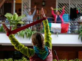 Personal trainer Antonietta Orsini carries out an exercise class for her neighbours from her balcony while Italians cannot leave their homes due to the coronavirus disease (COVID-19) outbreak, in Rome, Italy, March 18, 2020. "Sure, the gym is closed, but unless you are in quarantine, you can still go out for a brisk walk or run. Or check out exercise routines online," Victor Schukov writes.