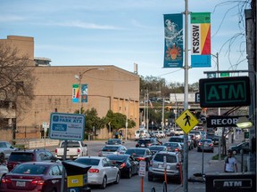 Cars wait at a traffic light on 7th St. after the South by Southwest (SXSW) music and tech festival was cancelled over growing concerns related to the coronavirus outbreak in Austin, Tex., on Friday, March 6, 2020.