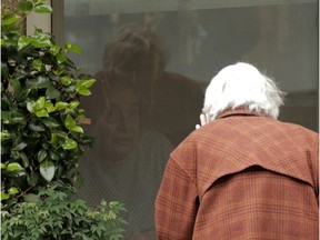 Dorothy Campbell waves while talking through a window to Gene Campbell, her husband of more than 60 years, at the Life Care Center of Kirkland, the long-term-care facility linked to several confirmed coronavirus cases in the state, in Kirkland, Washington, on Thursday, March 5, 2020.