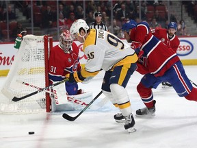 Nashville Predators centre Matt Duchene and Montreal Canadiens defenceman Christian Folin battle for the puck in front of goaltender Carey Price during the first period at Bell Centre in Montreal.