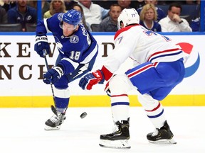 Lightning' Ondrej Palat passes the puck past Canadiens defenceman Brett Kulak during first period Thursday night at Amalie Arena.