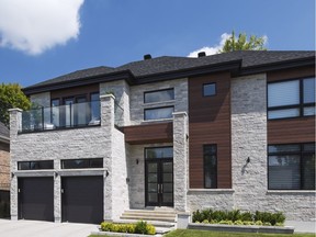 Grey cut stones, brown stained wood and the black garage doors and trim makes for an imposing-looking residence with a graphic architectural design style.