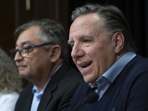 Quebec Premier Francois Legault, right, announces measures against Covid-19 virus, Saturday, March 14, 2020 at the legislature in Quebec City as Quebec national public health director Horacio Arruda, left, looks on.