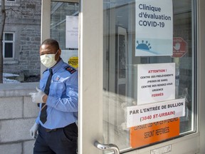 A security guard wears a protective mask in front of the new COVID-19 clinic at the site of the former Hotel Dieu hospital on March 9, 2020 in Montreal.