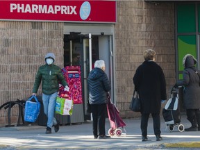 People line up at a Pharmaprix pharmacy in the Côte-Saint-Luc area of Montreal on March 21, 2020.