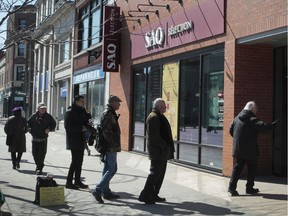 People line up outside an SAQ outlet in Westmount.