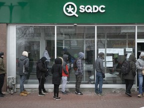 While consumption of booze and tobacco has been decreasing in Quebec, cannabis use has been pretty stable, a new survey found. Above: customers wait outside an SQDC outlet in this file photo.