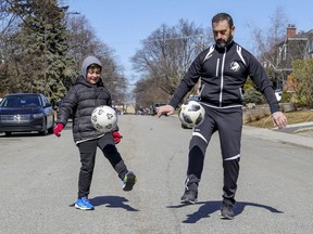 Joe De Fazio and his son Gabriele practise their soccer challenge outside their home in Lachine.