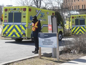 Security guard at the entrance of ambulance for triage of COVID-19, at the Verdun hospital on Tuesday March 31, 2020.