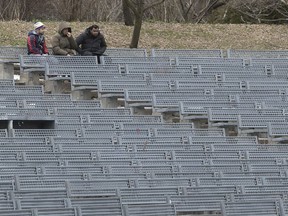 Three people gather in La Fontaine Park on Wednesday, April 1. Quebec Premier François Legault repeated the social distancing rules at his Thursday briefing: only go out for essential reasons, maintain a six-foot distance from other people, and wash your hands when you get home.