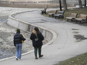 Two women walk together at Lafontaine Park in Montreal on April 1, 2020.