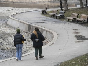 Two women walk in La Fontaine Park on Wednesday. “We’re asking everyone of course to respect the rules and not to crowd the parks," Mayor Valérie Plante said.