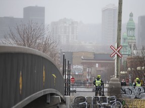 Police patrol the footpath by the newly closed bridge at Atwater Market in Montreal, Quebec April 5, 2020.