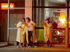 Quebec faces a high demand for personal protective equipment as a result of the pandemic. Above, staff at Anna-Laberge Hospital in Châteauguay react as police cars and fire trucks go by with lights and horns blaring in a show of solidarity.