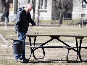 David Glashan cleans litter in N.D.G. Park on April 8, 2020. "I was going to the park and I saw a lot of trash around and decided to be productive, for my own mental sanity," he said.