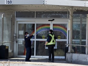 A security guard gives a delivery truck driver instructions at the CHSLD Ste-Dorothée, said be the site of over 100 cases of COVID-19.