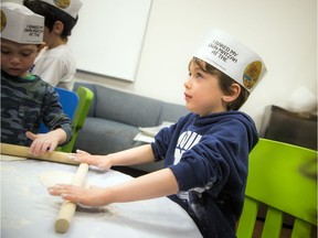 Solomon McEvenue rolls out his matzah before it goes in the oven, in this 2019 Passover photo. This year, Jewish families will not be gathering in numbers because of the COVID-19.