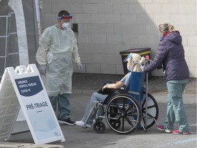 A medical worker is brought in for COVID-19 triage at Verdun hospital April 8, 2020.