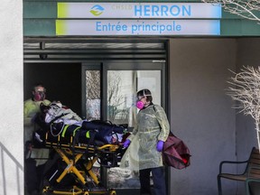 Paramedics wheel a resident out of CHSLD Herron in Dorval, west of Montreal April 8, 2020.