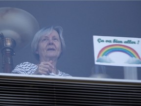 Seniors do exercises on their balcony or in their window at l'image d' Outremont seniors residence as the city deals with the coronavirus pandemic in Montreal, on Monday, April 6, 2020.