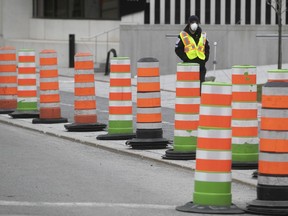 A security guard at the drive-in COVID-19 clinic at Place des Festivals on Thursday, April 9, 2020.