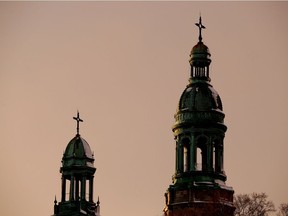 The sun sets on the steeples of St. Irénée Church in Montreal on Jan. 4, 2017.