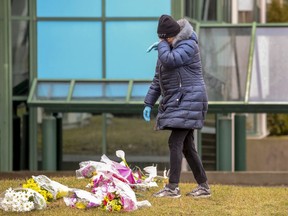 Mary cries after leaving flowers at Résidence Herron in Dorval, where 31 seniors have died since the end of March. Mary's mother was a former resident at the long-term care facility.