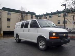 A van from a funeral home leaves the garage at Résidence Herron in Dorval. Thirty-one people have died at the long term care facility since the end of March.