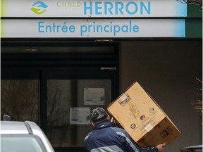 A man makes a delivery at Résidence Herron in Dorval on Monday, April 13, 2020.  More than 30 people have died at the long-term care facility since March.