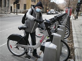 Norbert Lavoie gets ready to enjoy a Bixi ride at the Laurier St. station on the first day of the season on Wednesday.