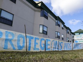 A sign calling to protect our seniors was erected outside Résidence Herron in Dorval on Wednesday.
