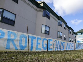 A sign saying Protégeons nos aînés (Let's protect our seniors) was erected outside Residence Herron in Dorval, west of Montreal, Wednesday April 15, 2020.