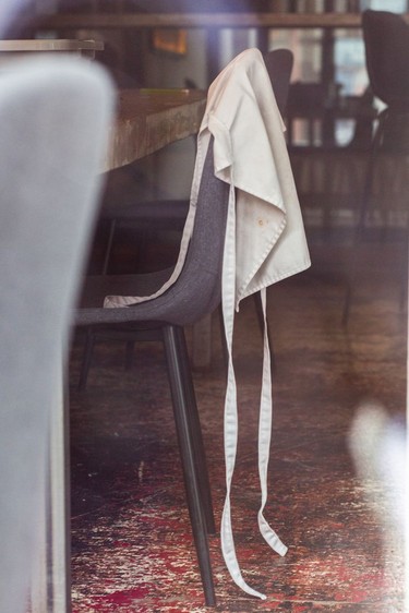 An apron sits on an empty chair at Le Mousso, which has been closed because of the coronavirus pandemic.