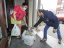 Montreal blue-collar worker André Prud'homme delivers groceries to Rosie Dela Cruz on behalf of the Depot Community Food Centre in Notre-Dame-de-Grâce on Thursday. 