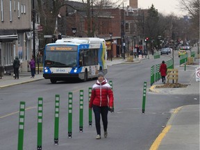 Catherine Robitaille walks along a widened sidewalk on Monkland Ave. on Sunday. It's one of the pedestrian corridors opening in several boroughs to facilitate social distancing.