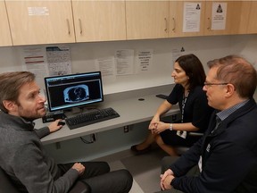 from left: Dr. Tarek Hijal. director of the Division of Radiation Oncology at the McGill University Health Centre, with radiation oncologist Dr. Joanne Alfieri and medical physicist Horacio Patrocinio, looking at patient MRI images. Photo courtesy Radiation Oncology, MUHC