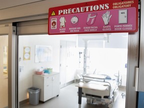 A sign outlines  precautions to be taken entering a room designated to treat potential COVID-19 patients at the Jewish General Hospital.
