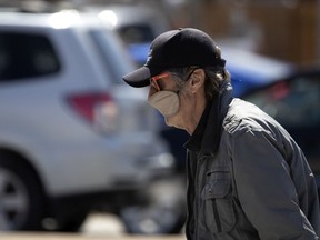 A man uses a sleep mask to cover his mouth and nose during the coronavirus pandemic