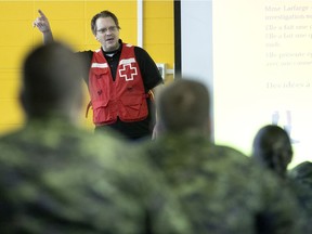 Members of the 5 GBMC get instruction from Red Cross teacher Martin Roy in Montreal on Wednesday as Deputy Premier Geneviève Guilbault announced 400 new soldiers will soon join them to help in Quebec CHSLDs.