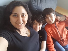 Lynda Kachaami poses for photo with her 8-year-old son Alex (middle), who has Duchenne muscular dystrophy, and her 11-year-old son, Gabriel, who has autism.