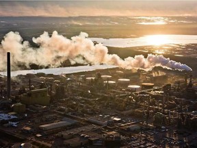 The setting sun reflects off a tailings pond behind Syncrude's oilsands upgrading facility north of Fort McMurray, Alta. on June 18, 2013. Downturns like the one being caused by the global pandemic routinely reduce carbon dioxide emissions. In the past, they’ve always recovered as economies rebuild.
This time, many are asking how the economy can be restored without greenhouse gases tagging along. Open letters on the issue have already been signed by hundreds of thousands of Canadians, from academics to church groups.